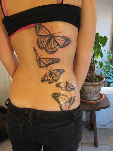 Girl with sexy butterfly tattoo body back